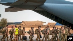 FILE - French Barkhane force soldiers who wrapped up a tour of duty in the Sahel leave their base on a transport plane in Gao, Mali, June 9, 2021.