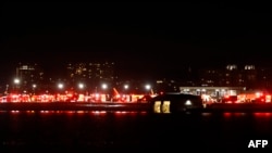 Lights from emergency vehicles are seen at Reagan National Airport in Washington, DC, after an air crash near the Potomac River on January 29, 2025.
