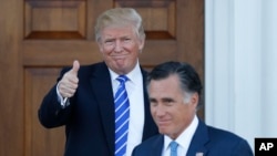 President-elect Donald Trump gives the thumbs-up as Mitt Romney leaves Trump National Golf Club Bedminster in Bedminster, N.J., Nov. 19, 2016. 
