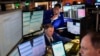 FILE - Traders work on the floor at the New York Stock Exchange in New York, Feb. 3, 2025. 