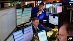 FILE - Traders work on the floor at the New York Stock Exchange in New York, Feb. 3, 2025. 