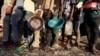 Ethiopian refugees who fled Tigray region, queue to receive food aid within the Um-Rakoba camp in Al-Qadarif state, on the border, in Sudan, December 11, 2020.