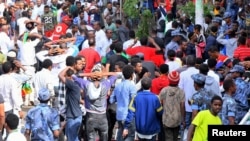 FILE - Ethiopians react after an explosion during a rally in support of the new Prime Minister Abiy Ahmed in Addis Ababa, Ethiopia, June 23, 2018. 
