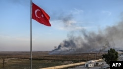 Dans cette ville turque, à un jet de pierre de Tal Abyad, les rues sont désertes et seule une poignée d'habitants brave le danger pour observer une épaisse fumée noire qui monte depuis la frontière.