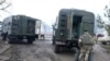Ukrainian soldiers load the surviving equipment at a destroyed Ukrainian military facility outside Mariupol, Ukraine, Feb. 24, 2022. Russia has launched a barrage of air and missile strikes on Ukraine early Thursday and Ukrainian officials said that Russi