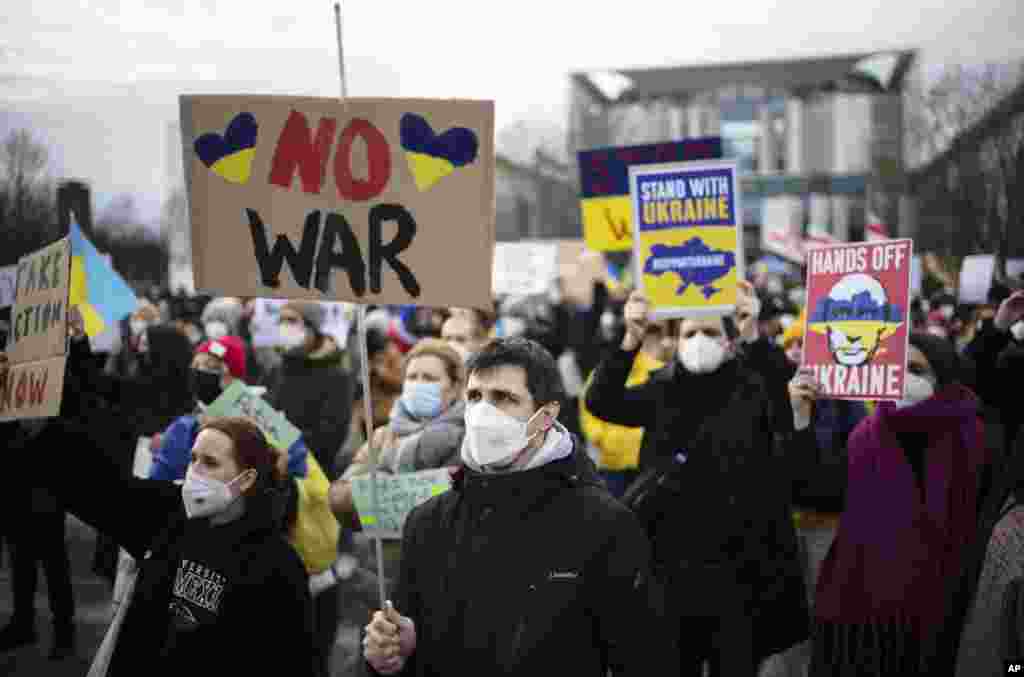 People protest against Russia and Russian President Putin after Russian troops have launched their anticipated attack on Ukraine, in front of the chancellery in Berlin, Germany, Feb. 24, 2022.