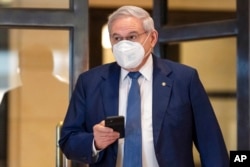 FILE - Sen. Bob Menendez, D-N.J., walks from closed-door briefing on Capitol Hill, Feb. 2, 2022.