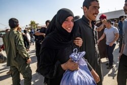 A man, suspected of having collaborated with the Islamic State (IS) group, is greeted by a family member upon his release from the Kurdish-run Alaya prison in the northeastern Syrian city of Qamishli, on Oct. 15, 2020.