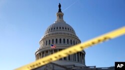 Police tape marks a secured area of the Capitol, Jan. 19, 2018, in Washington. 