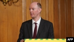 FILE - Britain's Chief Medical Officer for England Chris Whitty attends a remote press conference to update the nation on the COVID-19 pandemic, inside 10 Downing Street in central London on June 10, 2020.