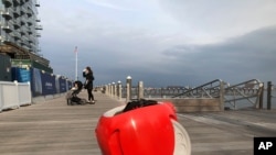 FILE - A cargo-carrying robot called the Gita sits near a waterfront park on Nov. 11, 2019, in Boston.