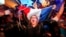 Supporters of far-right candidate Marine Le Pen, celebrate in Henin-Beaumont, northern France, after exit poll results of the first round of the presidential election are announced, April 23, 2017.
