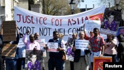 Demonstrators carry placards demanding justice for Asifa, an 8-year-old Muslim girl who was raped and murdered in India, during a rally protesting a visit by Indian Prime Minister Narendra Modi, in London, April 18, 2018. 