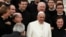 Pope Francis poses with a group of priests at the end his Wednesday general audience in Saint Peter's square at the Vatican Feb. 26, 2014.