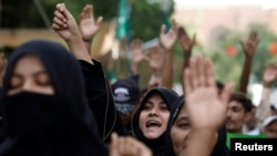 People chant slogans against the satirical French weekly newspaper 'Charlie Hebdo', which reprinted a cartoon of the Prophet Muhammad, and condemn the burning of the holy Quran in Sweden, during a protest in Karachi, Pakistan, Sept. 6, 2020.