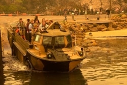 Evacuees are transported, Jan. 2, 2020, in an amphibious vehicle from Mallacoota, Victoria, Australia.