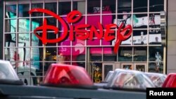 FILE - The logo of the Times Square Disney store is seen in Times Square, New York City, Dec. 5, 2019. 
