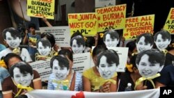 Activists from the Free Burma Coalition holding masks of Burmese democracy icon Aung San Suu Kyi at a rally in front of the Burmese Embassy in Manila in November 2010.