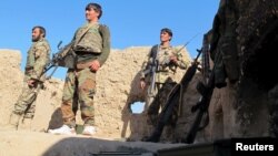 Afghan National Army (ANA) soldiers stand at an outpost in Helmand province, Dec. 20, 2015.