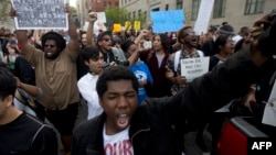 A demonstrator shouts during a protest in downtown Baltimore, Maryland, on April 29, 2015, seeking justice for an African-American man who died of severe spinal injuries sustained in police custody.
