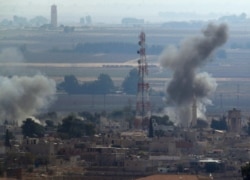 In this photo taken from the Turkish side of the border between Turkey and Syria, in Ceylanpinar, Sanliurfa province, southeastern Turkey, smoke billows from targets in Ras al-Ayn, Syria, caused by bombardment by Turkish forces, Wednesday, Oct. 16,…