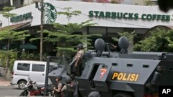 A police armored vehicle is parked outside a Starbucks cafe after an explosion in Jakarta, Indonesia, Jan. 14, 2016. 
