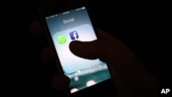 FILE - A photo shows the Facebook app icon on an iPhone in New York, Feb. 19, 2014.