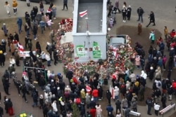People gather to honor 31-year-old Raman Bandarenka, who died at a Minsk hospital after several hours of surgery due to serious injuries in Minsk, Belarus, Nov. 13, 2020.