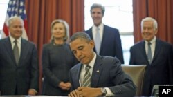 US President Barack Obama signs the new Strategic Arms Reduction Treaty [START] in the Oval Office of the White House in Washington, February 2, 2011.