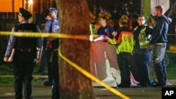 Emergency personnel work at the scene after a person was run over and killed by a float during The Mystic Krewe of Nyx Mardi Gras parade in New Orleans, Feb. 19, 2020.