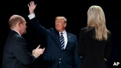 President Donald Trump waves as he arrives for the National Prayer Breakfast, Feb. 8, 2018, in Washington. 