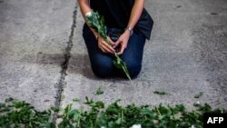 An artist takes part in a performance art in the Causeway Bay district of Hong Kong on June 3, 2021, to mourn the victims of China's deadly Tiananmen Square crackdown.