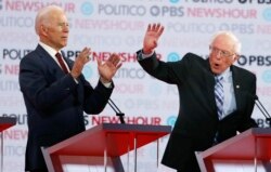 Democratic presidential candidates former Vice President Joe Biden, left, and Sen. Bernie Sanders, I-Vt., speak during a Democratic presidential primary debate, Dec. 19, 2019, in Los Angeles.