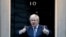 Britain's Prime Minister Boris Johnson shows thumbs up before he applauds on the doorstep of 10 Downing Street in London during the weekly "Clap for our Carers," April 30, 2020. 