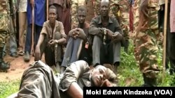 Former hostages who were freed by the military after being held by armed men from the Central African Republic, are seen with chains on their hands and legs after being returned to Cameroon, June 6, 2018. 