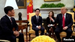 U.S. President Donald Trump meets with North Korean defectors in the Oval Office of the White House in Washington, Feb. 2, 2018. 