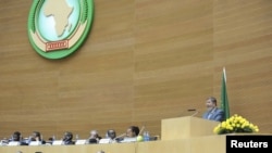 Egypt's President Mohamed Morsi (R) delivers a speech during the opening of the African Union (AU) leaders' meeting in Addis Ababa, July 15, 2012. 