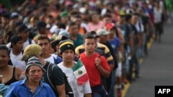 Honduran migrants take part in a caravan heading to the US on the road linking Ciudad Hidalgo and Tapachula, Chiapas state, Mexico, Oct. 21, 2018.