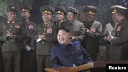 North Korean leader Kim Jong Un watches night naval fire strike drill of navy warship sub-unit and ground artillery sub-units in this undated photo released by North Korea's Korean Central News Agency (KCNA) on June 16, 2015.