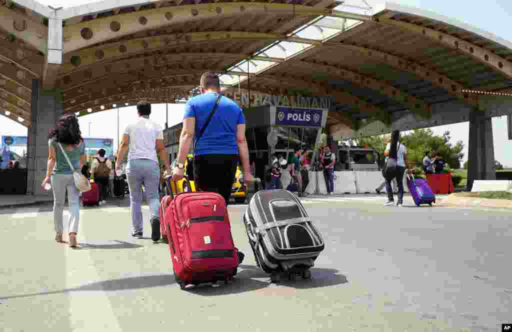 Passengers pull their bags as they arrive at Sabiha Gokcen Airport, in Istanbul, July 17, 2016.&nbsp;Rather than toppling the country's strongman president, a failed military coup appears to have bolstered Recep Tayyip Erdogan's immediate grip on power and boosted his popularity.&nbsp;