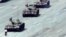 FILE - A Beijing citizen stands in front of tanks on the Avenue of Eternal Peace, June 5, 1989.