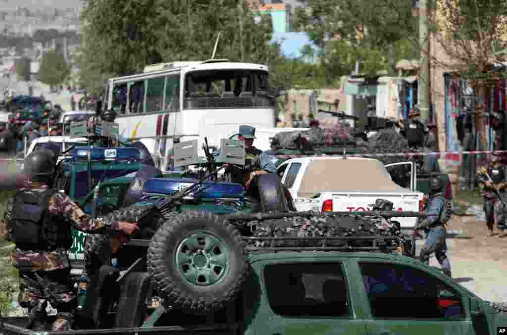 Afghan security forces inspect the site of a suicide attack in which two people were killed and about 20 people wounded in Kabul, May 4, 2015.