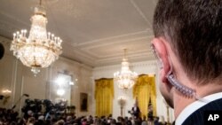 FILE - A Secret Service agent stands as President Donald Trump speaks during a news conference in the East Room of the White House in Washington, Feb. 16, 2017.