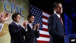 Republican presidential candidate Mitt Romney is applauded by sons Josh, center, and Tagg, left, as he speaks at a Colorado Conservative Political Action Committee (CPAC) meeting in Denver, October 4, 2012.