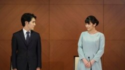 Japan's former Princess Mako, the elder daughter of Crown Prince Akishino and Crown Princess Kiko, and her husband Kei Komuro, look at each other during a press conference to announce their marriage at a hotel in Tokyo, Japan, Oct. 26, 2021. 