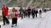 FILE - People cross the Georgia-Russia border at Verkhny Lars, Georgia, Sept. 28, 2022. The Kremlin's announcement of a partial mobilization had sent waves of panic throughout the country. Flights abroad sold out and long lines formed at border crossings.
