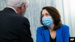 Chairman Roger Wicker, R-Miss., and ranking member Sen. Maria Cantwell , D-Wash., confer during the Senate Commerce, Science, and Transportation Committee confirmation hearing for nominee for Secretary of Commerce, Gina Raimondo, Jan 26, 2021.