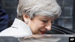 Britain's Prime Minister Theresa May leaves after a meeting with the Leader of Northern Ireland's Democratic Unionist Party (DUP) Arlene Foster at 10 Downing Street after the general election in London, June 13, 2017. 