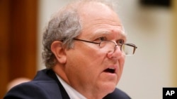 FILE - John Sopko, U.S. special inspector general for Afghanistan reconstruction, testifies before a U.S. House committee on U.S. efforts in Afghanistan, June 10, 2014. 
