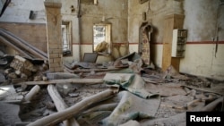 A damaged mosque is seen in the besieged town of Douma in eastern Ghouta in Damascus, Syria, March 1, 2018. 